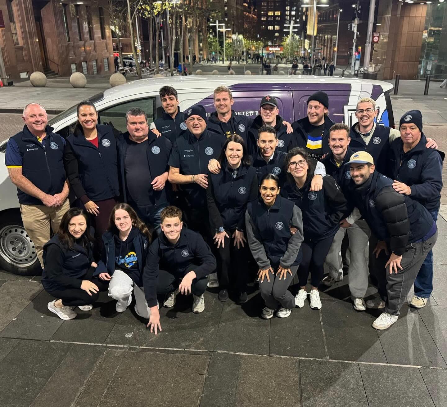 Volunteers gathered in front of the A Touch of Kindness van