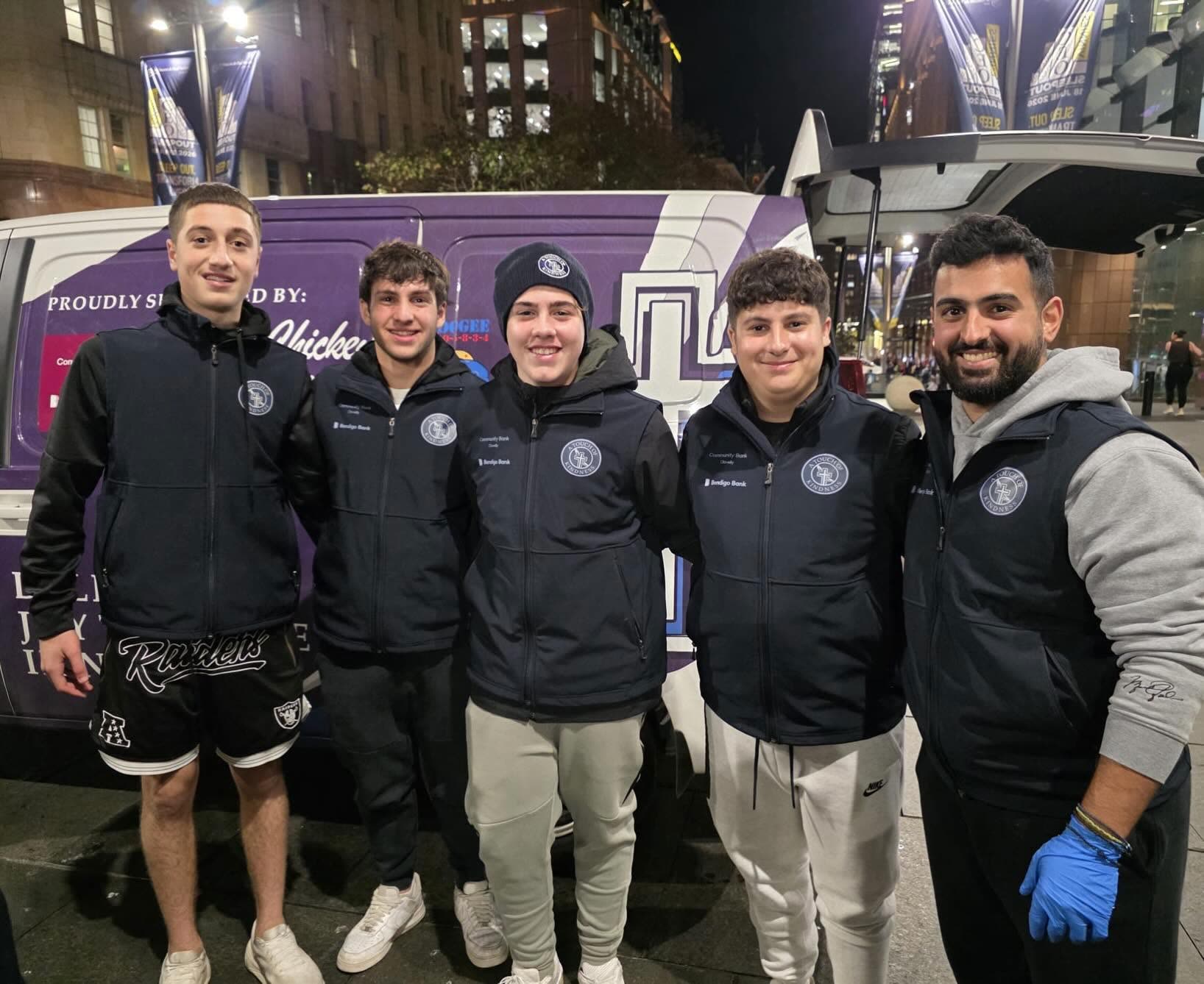 Young volunteers in front of the A Touch of Kindness van